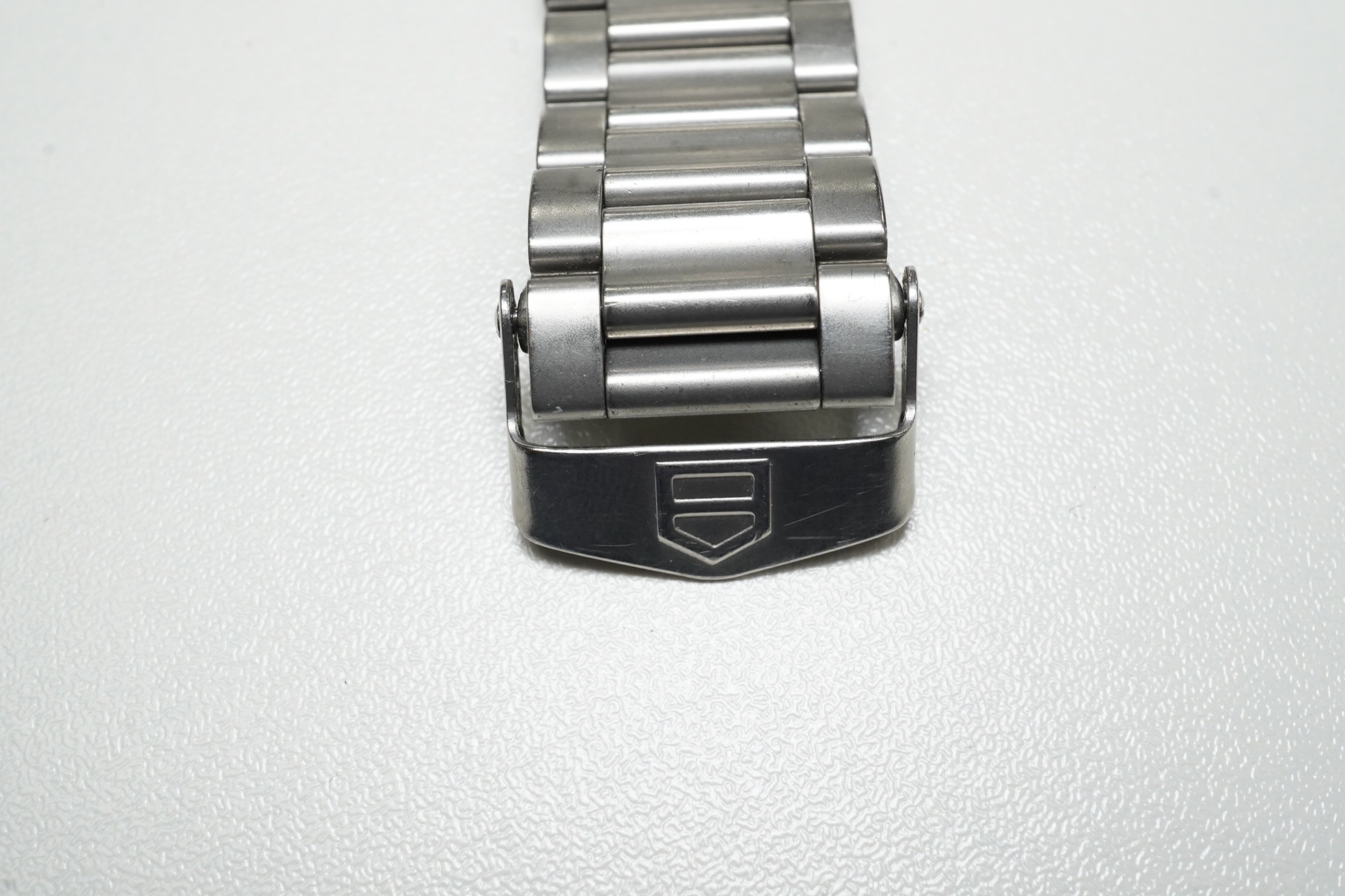 A gentleman's stainless steel Tag Heuer automatic wrist watch, with baton numerals and date aperture, case diameter 38mm, together with a battery operated winder. Condition - poor to fair